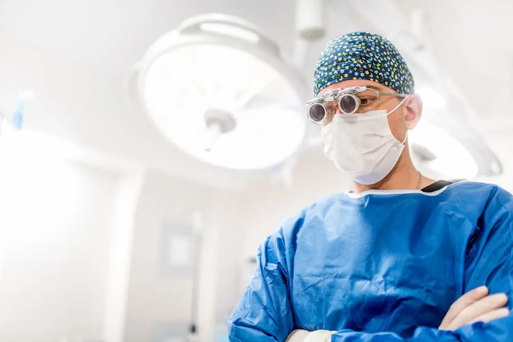 cosmetic plastic surgeon with loupes scrubs and ru PRW7TM2 1