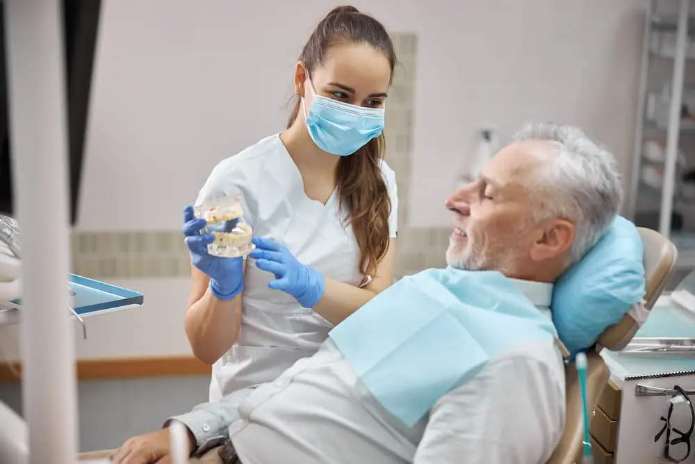 qualified female dental specialist holding dental 6V6N2NR 1