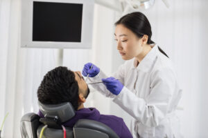 asian dentist examines the oral cavity of young be 2023 11 27 05 27 47 utc